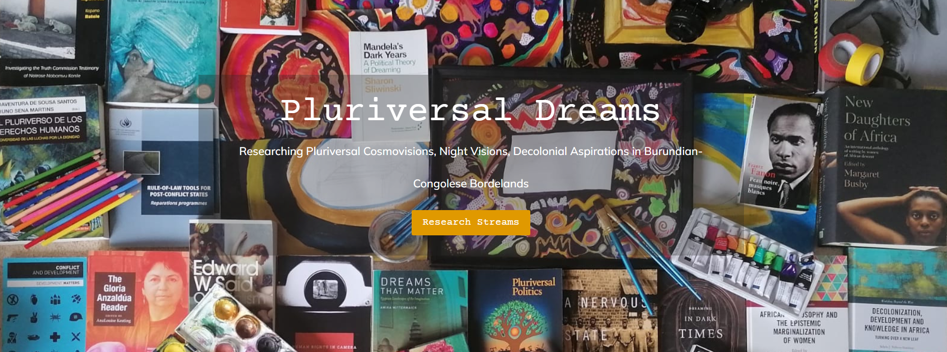 Banner image from the Pluriversal Dreams home page eith a selection of books and art materials 