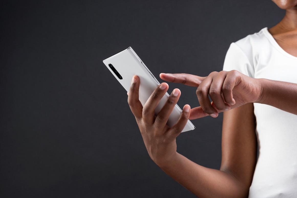An African man holding a mobile phone