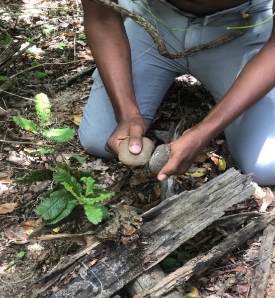 A man rubbing two stones together