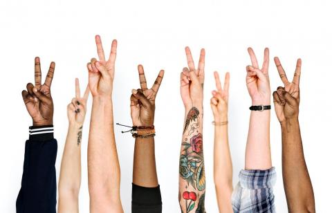 Multiracial peace hands Hands from multiple ethnicities all showing the peace sign